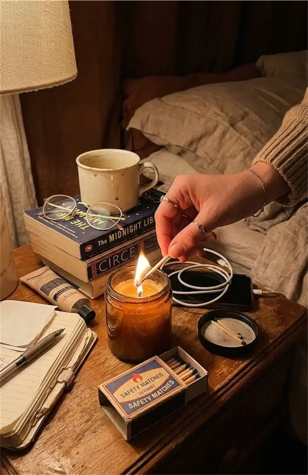lighting candle nightstand evening routine cozy home peace self care anxiety relief